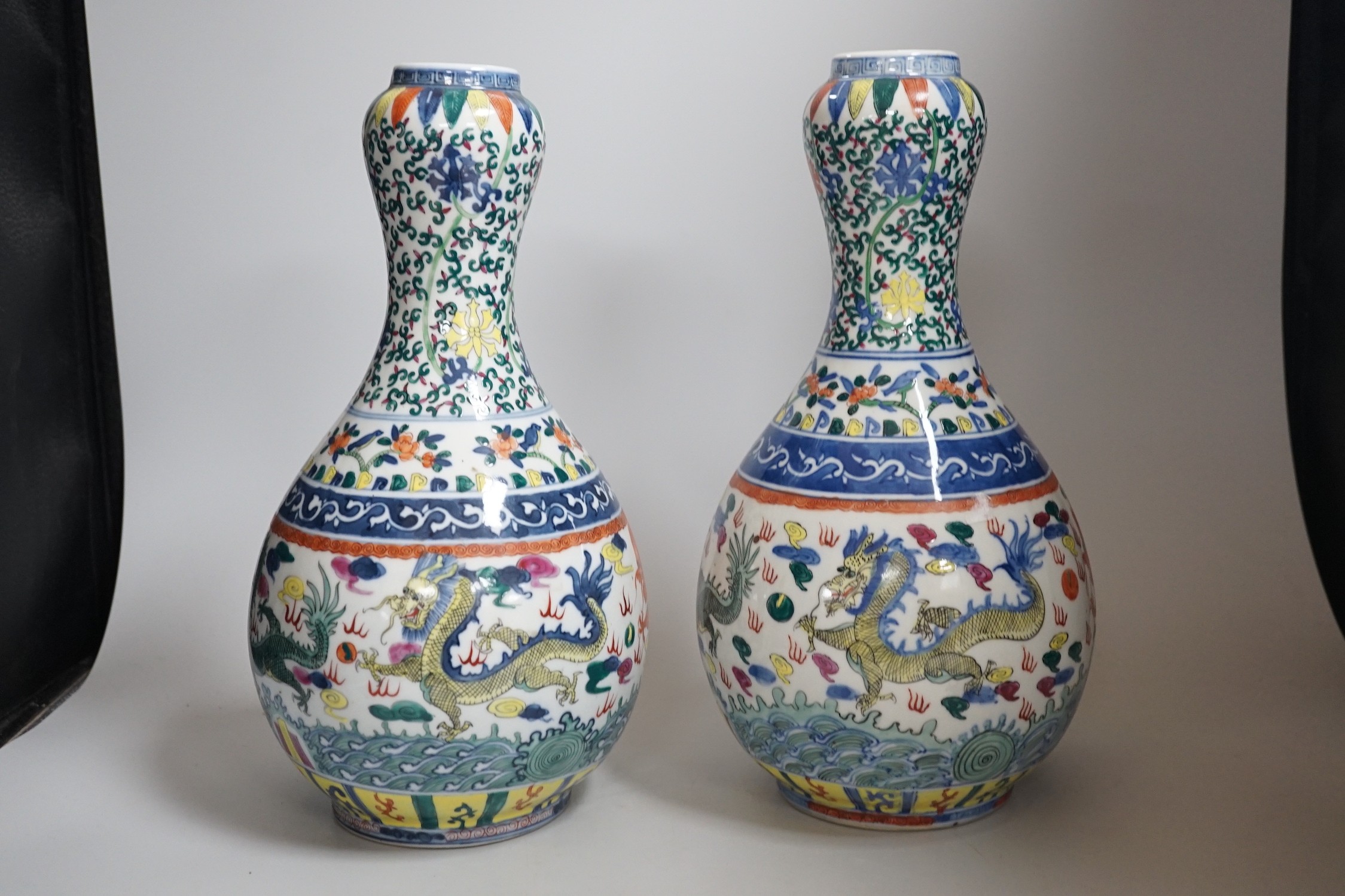 A pair of Chinese Wucai decorated vases, 34cms high